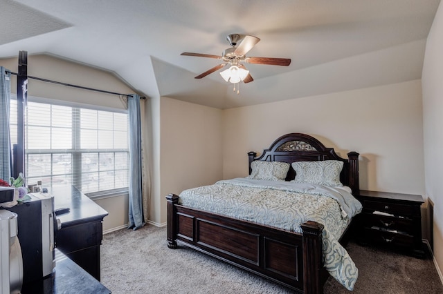 bedroom featuring baseboards, lofted ceiling, light carpet, and a ceiling fan