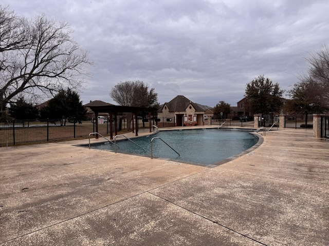 community pool featuring a patio and fence