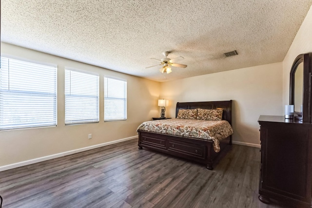 bedroom with dark wood-type flooring, visible vents, and baseboards