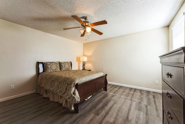 bedroom featuring a textured ceiling, wood finished floors, a ceiling fan, and baseboards