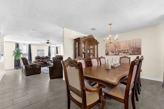 dining space featuring visible vents, a textured ceiling, and baseboards