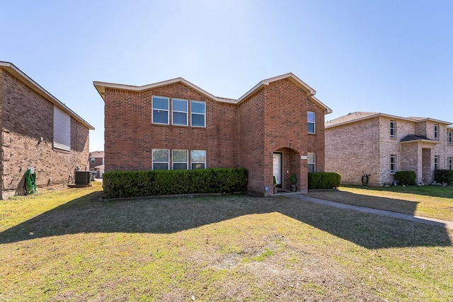 traditional-style house with brick siding, a front lawn, and central air condition unit