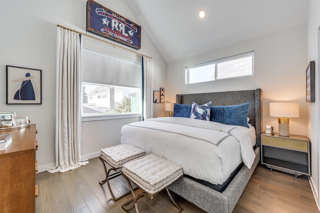 bedroom featuring lofted ceiling, baseboards, wood finished floors, and recessed lighting