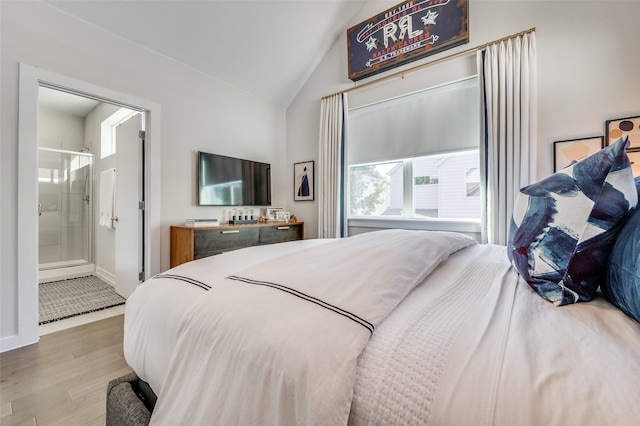 bedroom with lofted ceiling and wood finished floors