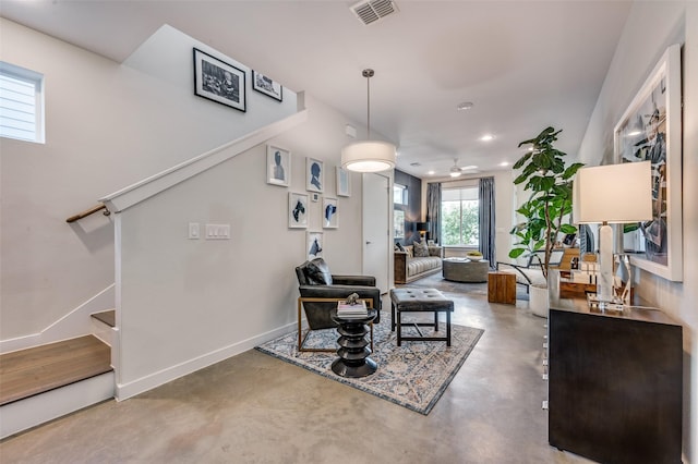 interior space featuring baseboards, visible vents, stairway, concrete floors, and recessed lighting