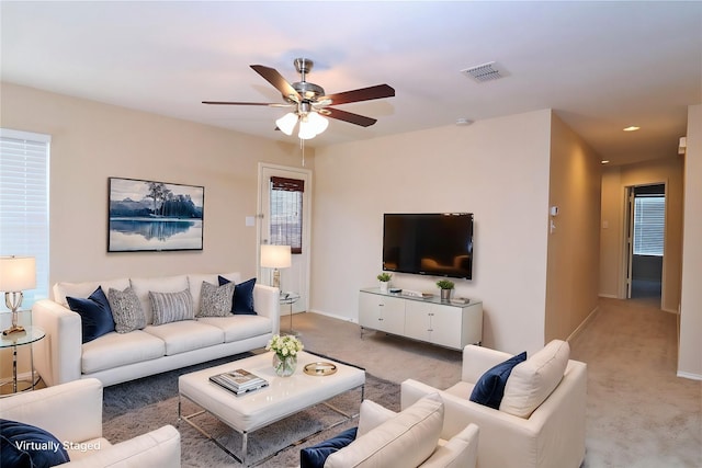 living room with recessed lighting, visible vents, a ceiling fan, light carpet, and baseboards