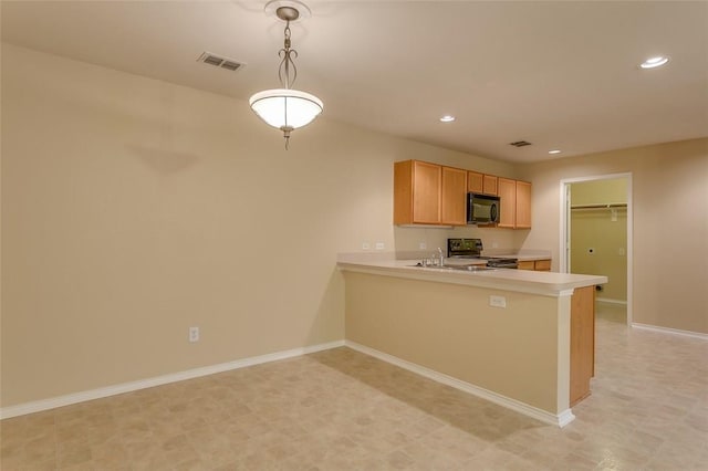 kitchen featuring baseboards, range, a peninsula, light countertops, and black microwave