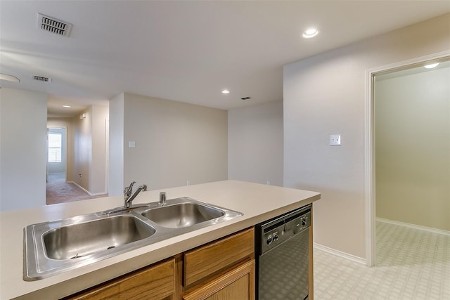 kitchen with a sink, visible vents, black dishwasher, light countertops, and brown cabinets