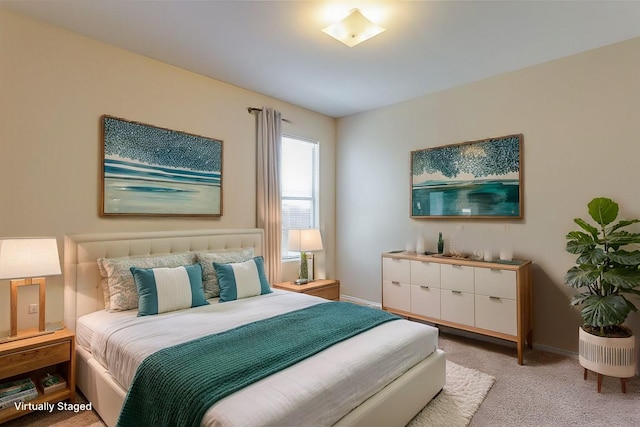 bedroom featuring baseboards and light colored carpet