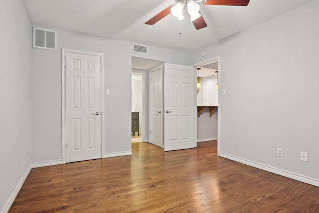 unfurnished bedroom with baseboards, visible vents, ceiling fan, and wood finished floors