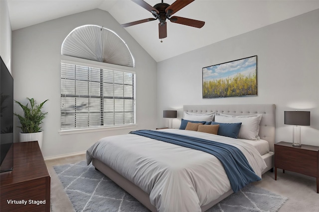 carpeted bedroom featuring vaulted ceiling, a ceiling fan, and baseboards