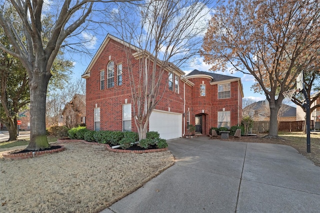 view of front of house featuring driveway, an attached garage, fence, and brick siding