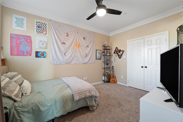 carpeted bedroom with ornamental molding, a closet, ceiling fan, and baseboards