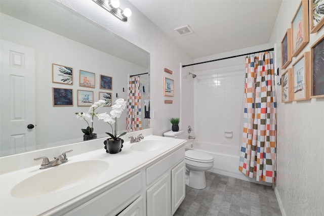 full bath featuring visible vents, a sink, toilet, and double vanity