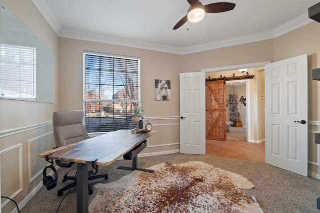 home office with a wainscoted wall, a barn door, and a wealth of natural light