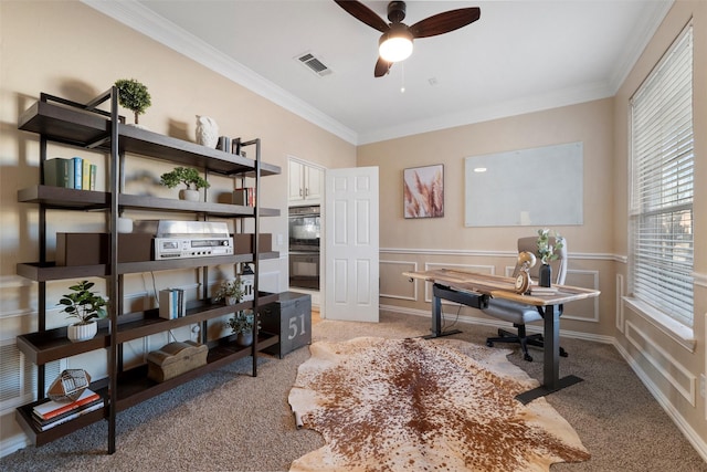 home office featuring visible vents, crown molding, light colored carpet, and a decorative wall