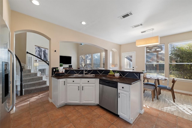 kitchen featuring a sink, dark countertops, visible vents, and dishwasher