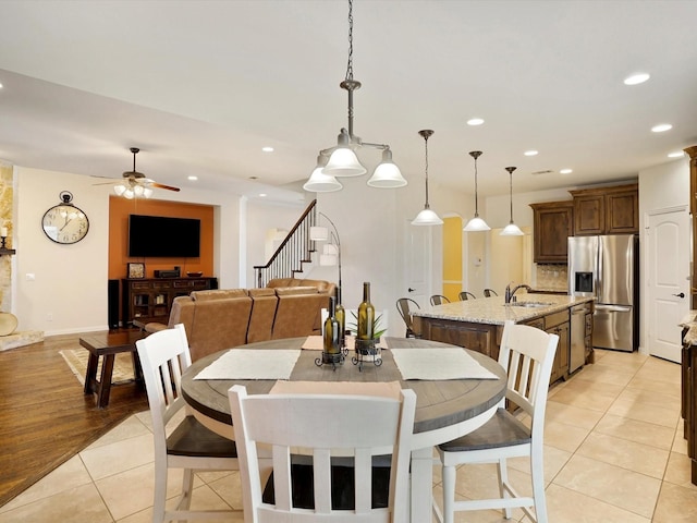 7132 Goodnight Ranch Rd, North Richland Hills, TX 76182 - dining space featuring light tile patterned floors, recessed lighting, ceiling fan, and stairway