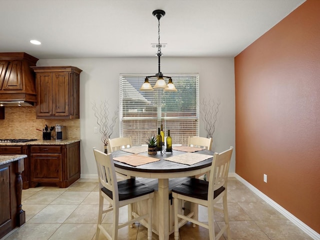 dining room featuring light tile patterned floors, visible vents, and baseboards