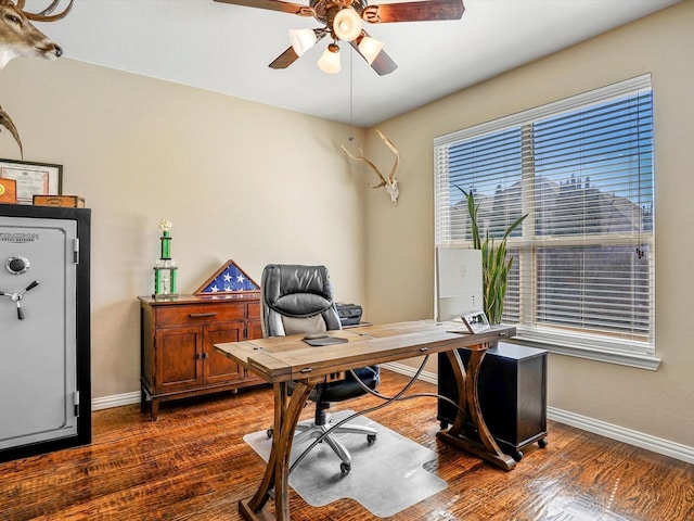 office space featuring dark wood-style floors, ceiling fan, and baseboards