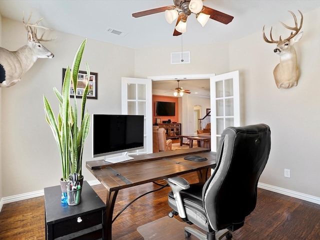 home office featuring a ceiling fan, wood finished floors, visible vents, and baseboards