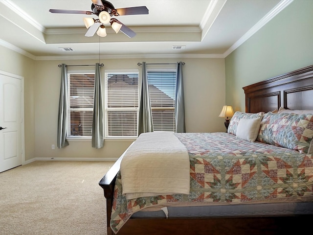 carpeted bedroom featuring baseboards, a raised ceiling, visible vents, and crown molding