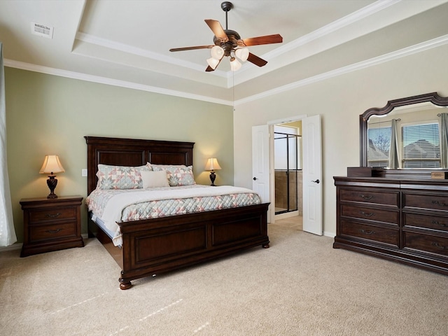 bedroom with visible vents, a ceiling fan, light colored carpet, ornamental molding, and a tray ceiling