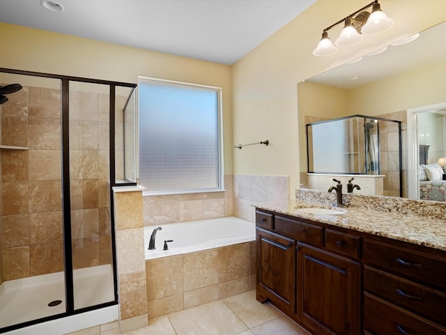 full bath featuring a garden tub, a shower stall, vanity, and tile patterned floors