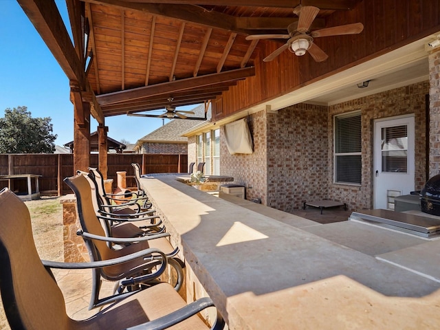 view of patio / terrace featuring ceiling fan and fence