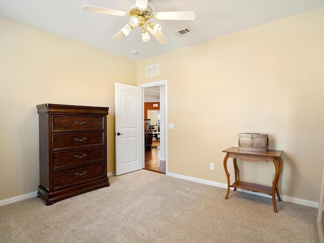 interior space featuring baseboards, visible vents, and light colored carpet