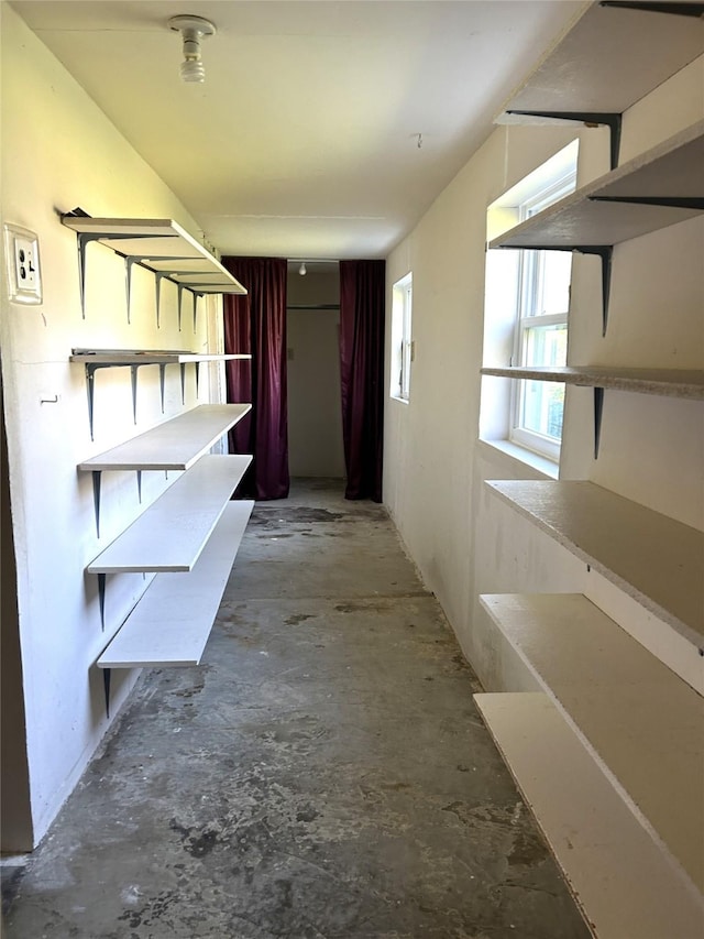 hallway featuring unfinished concrete floors