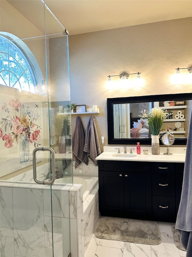 full bath featuring a bath, marble finish floor, a stall shower, and vanity