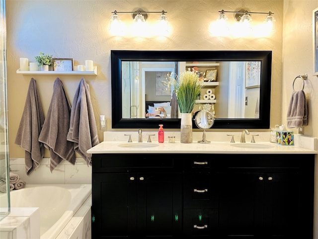 full bathroom featuring double vanity, a sink, and a bathtub