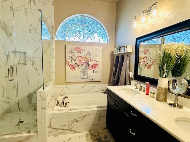 bathroom with double vanity, a sink, a marble finish shower, and a bath