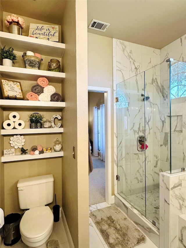 full bath featuring visible vents, toilet, and a marble finish shower