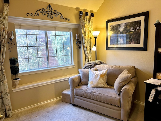 living area with lofted ceiling, carpet flooring, and baseboards