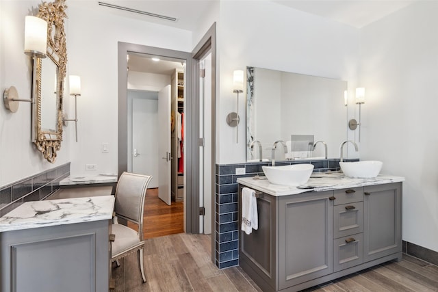 2300 Wolf St Unit 3D, Dallas, TX 75201 - bathroom with visible vents, a spacious closet, wood finished floors, and vanity