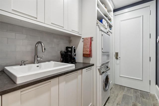 2300 Wolf St Unit 3D, Dallas, TX 75201 - washroom with laundry area, light wood-type flooring, a sink, and stacked washer / drying machine
