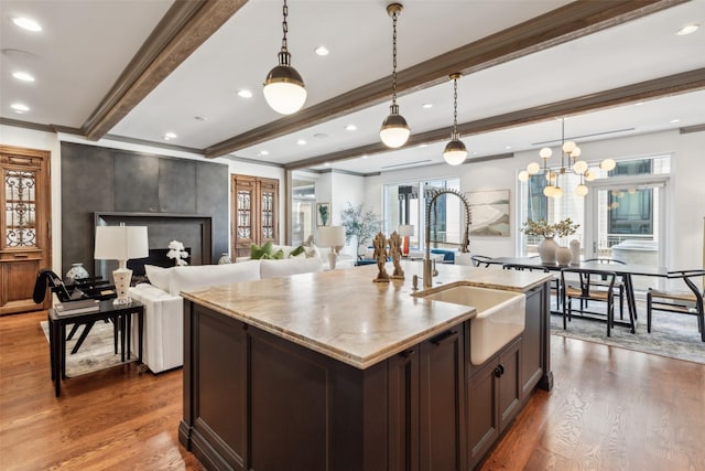 2300 Wolf St Unit 3D, Dallas, TX 75201 - kitchen with decorative light fixtures, beamed ceiling, a sink, and wood finished floors