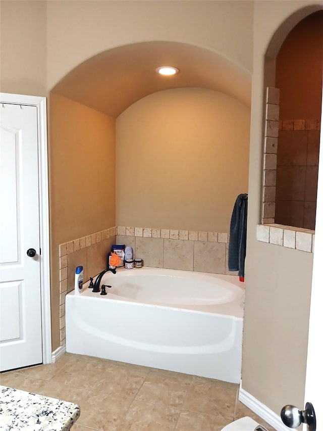 full bathroom featuring tile patterned floors and a garden tub