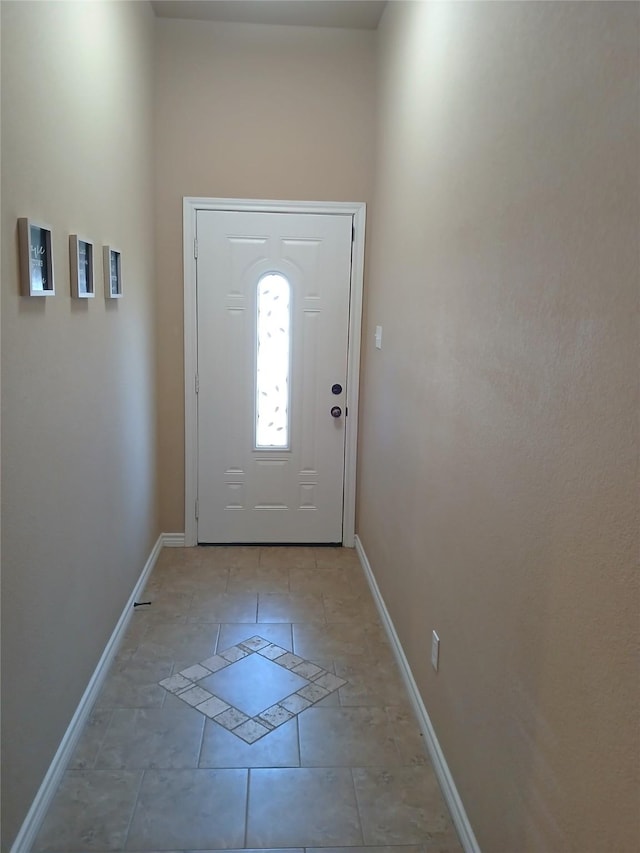 entryway featuring light tile patterned floors and baseboards