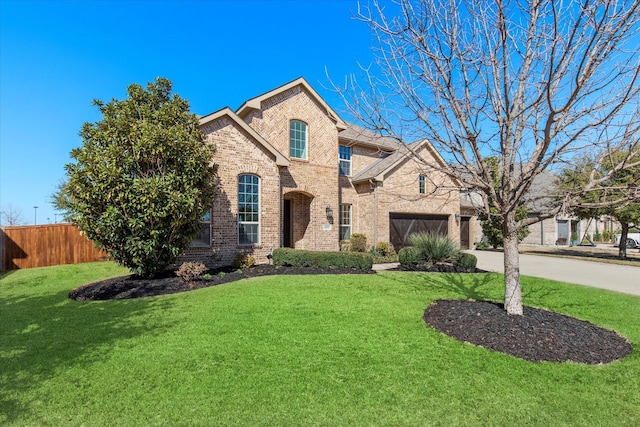 view of front of home with brick siding, a front lawn, fence, concrete driveway, and a garage