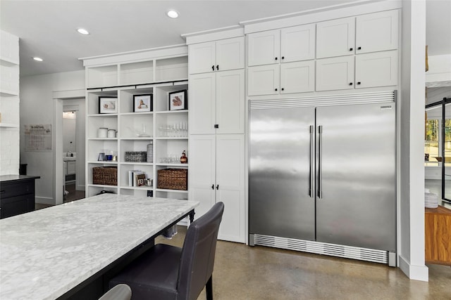 5949 County Road 137, Flint, TX 75762 - kitchen featuring stainless steel built in refrigerator, concrete floors, open shelves, white cabinetry, and light countertops