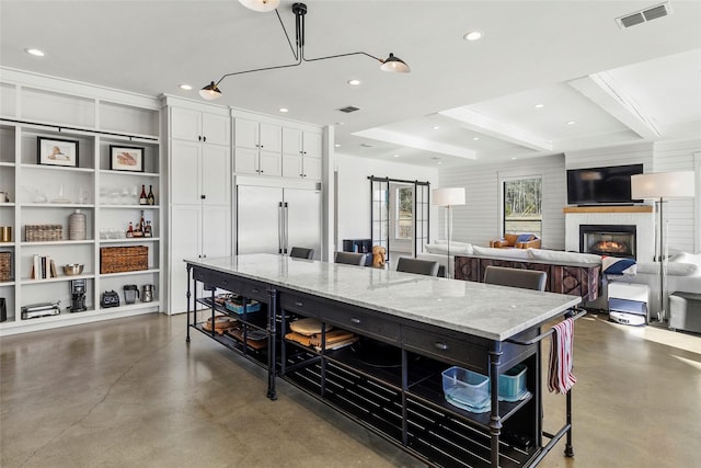 5949 County Road 137, Flint, TX 75762 - kitchen with built in fridge, concrete floors, a kitchen breakfast bar, a spacious island, and recessed lighting