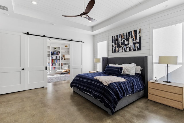 5949 County Road 137, Flint, TX 75762 - bedroom with a barn door, a tray ceiling, concrete flooring, wooden ceiling, and recessed lighting