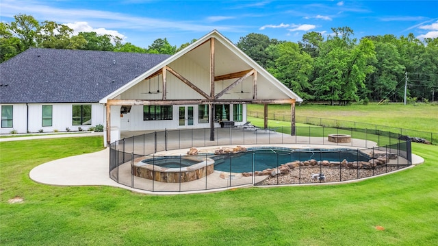 5949 County Road 137, Flint, TX 75762 - back of property with an in-ground hot tub, an outdoor fire pit, a patio area, and a shingled roof