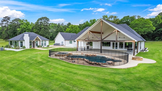 5949 County Road 137, Flint, TX 75762 - back of house featuring a fire pit, a patio area, a pool with connected hot tub, and a shingled roof