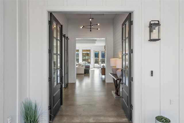 5949 County Road 137, Flint, TX 75762 - hallway with concrete flooring and a chandelier