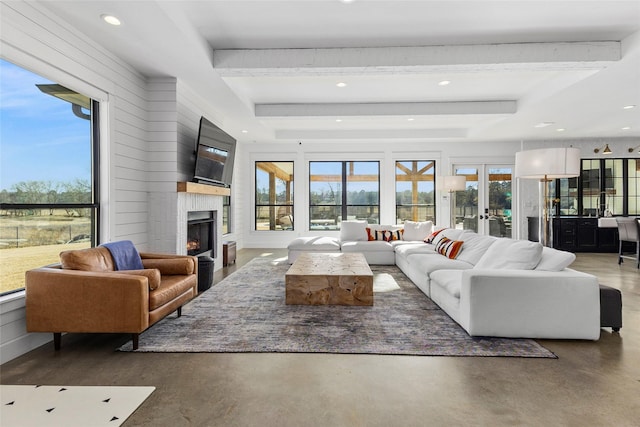 5949 County Road 137, Flint, TX 75762 - living room with healthy amount of natural light, a warm lit fireplace, recessed lighting, concrete floors, and french doors
