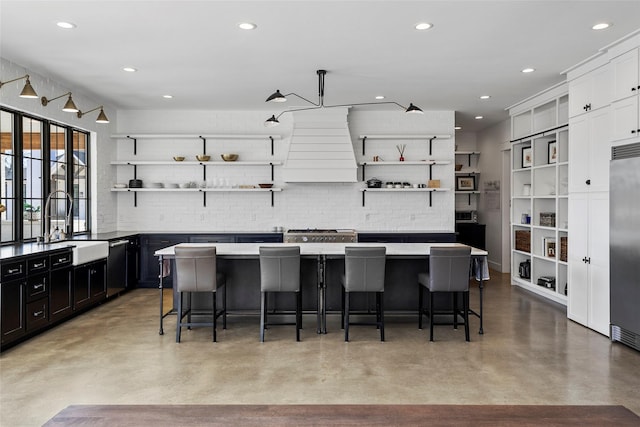 5949 County Road 137, Flint, TX 75762 - kitchen with open shelves, finished concrete floors, a sink, backsplash, and a kitchen island